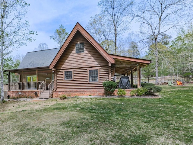 rear view of property featuring a porch, a lawn, and log siding
