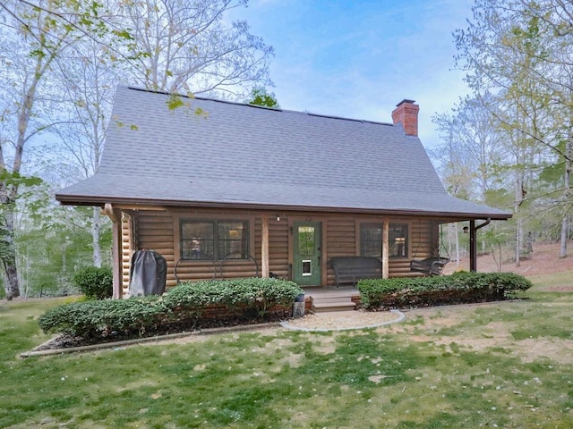 cabin featuring a chimney, a front lawn, log exterior, and a porch