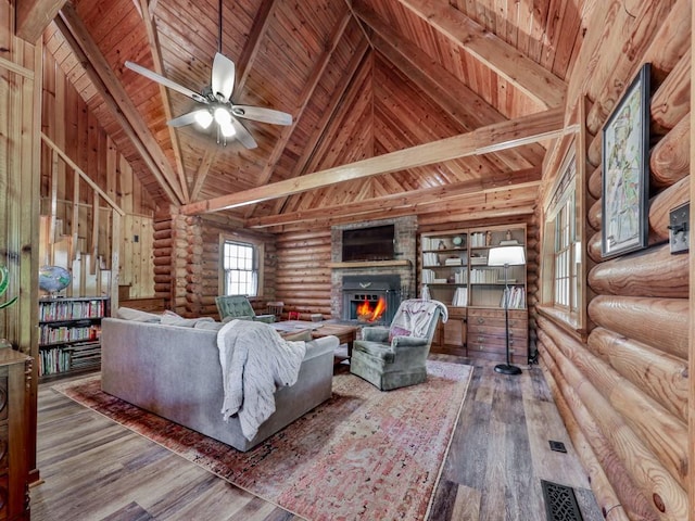 living room with wood ceiling, rustic walls, a glass covered fireplace, and wood finished floors
