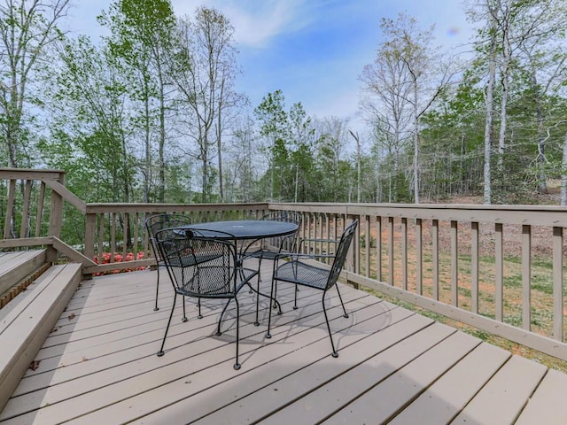 wooden terrace featuring outdoor dining space