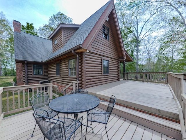 wooden terrace featuring outdoor dining area