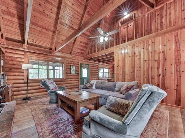 living area with high vaulted ceiling, wooden ceiling, a healthy amount of sunlight, and beam ceiling