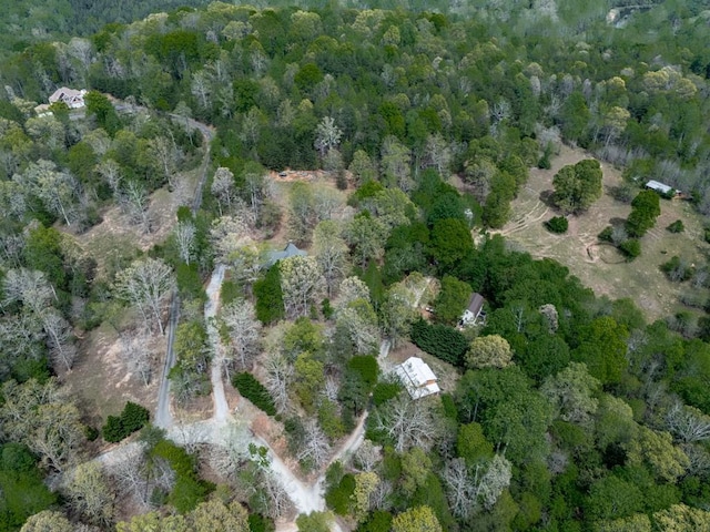 birds eye view of property with a view of trees