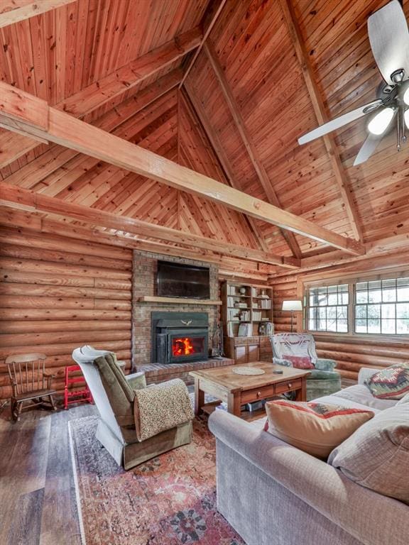 living room with rustic walls, beamed ceiling, ceiling fan, wooden ceiling, and high vaulted ceiling