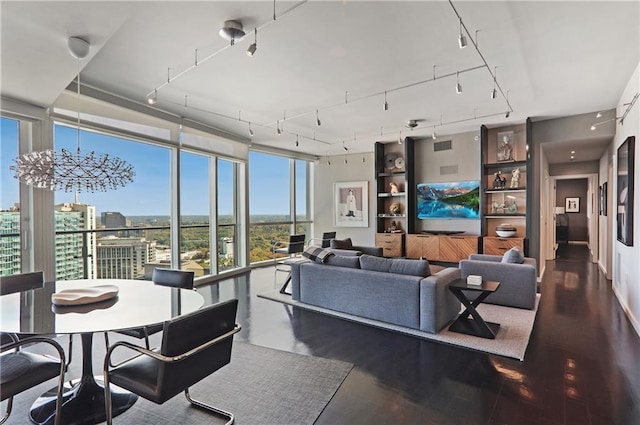 living room with a notable chandelier and expansive windows