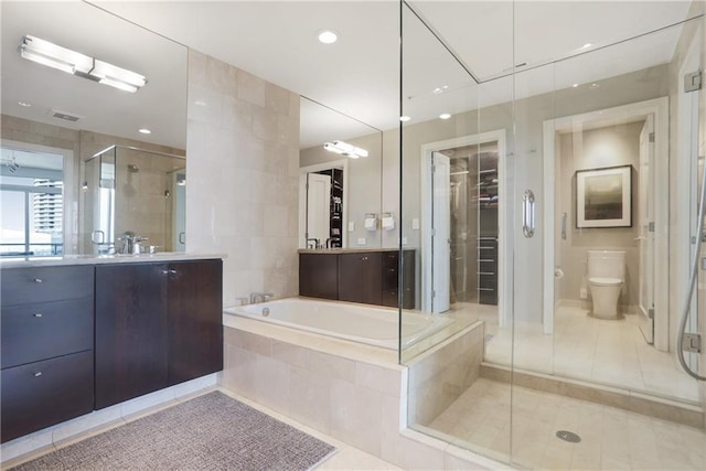 full bathroom with shower with separate bathtub, vanity, toilet, and tile patterned floors