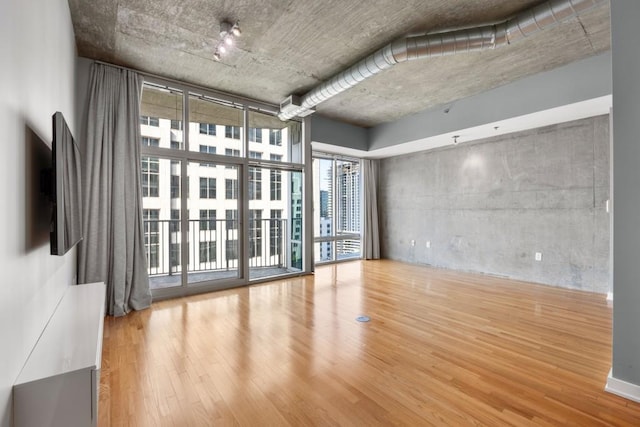 943 Peachtree St NE Unit 1109, Atlanta, GA 30309 - empty room with hardwood / wood-style flooring and expansive windows