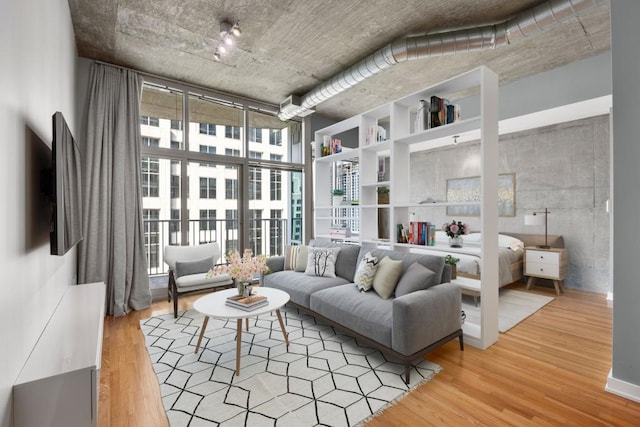 943 Peachtree St NE Unit 1109, Atlanta, GA 30309 - living room featuring hardwood / wood-style floors, floor to ceiling windows, and a towering ceiling