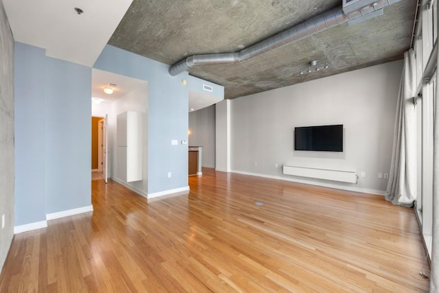 943 Peachtree St NE Unit 1109, Atlanta, GA 30309 - unfurnished living room with light hardwood / wood-style flooring
