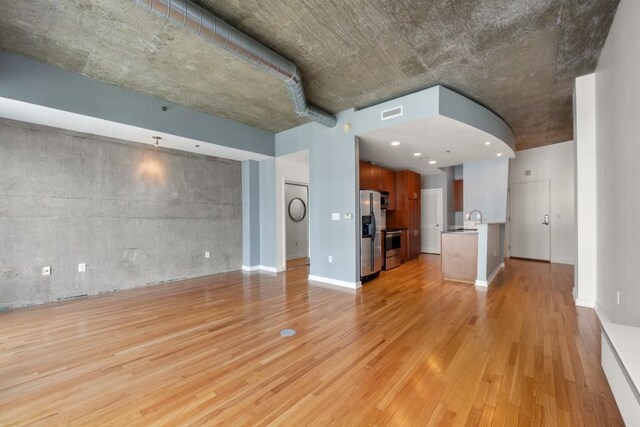 943 Peachtree St NE Unit 1109, Atlanta, GA 30309 - unfurnished living room with light hardwood / wood-style flooring and sink