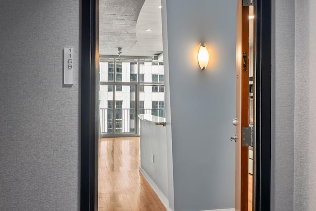 943 Peachtree St NE Unit 1109, Atlanta, GA 30309 - corridor featuring light hardwood / wood-style floors and floor to ceiling windows