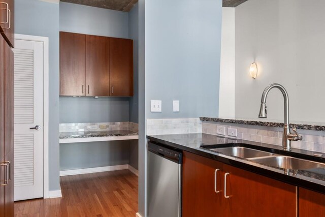 943 Peachtree St NE Unit 1109, Atlanta, GA 30309 - kitchen with dishwasher, light hardwood / wood-style floors, dark stone countertops, and sink
