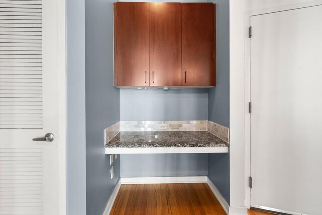 943 Peachtree St NE Unit 1109, Atlanta, GA 30309 - kitchen with dark stone countertops and wood-type flooring
