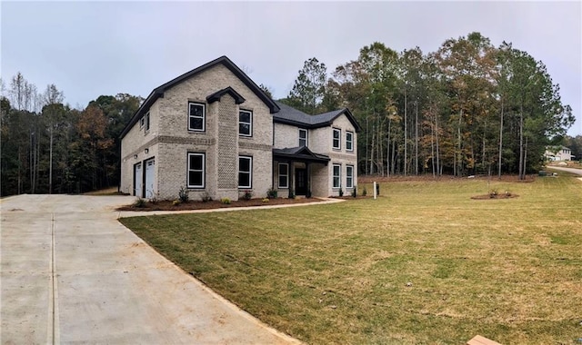 view of front facade with a garage and a front lawn