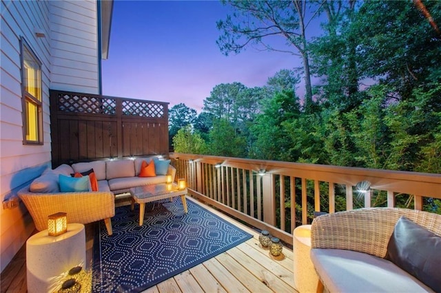 deck at dusk with an outdoor hangout area