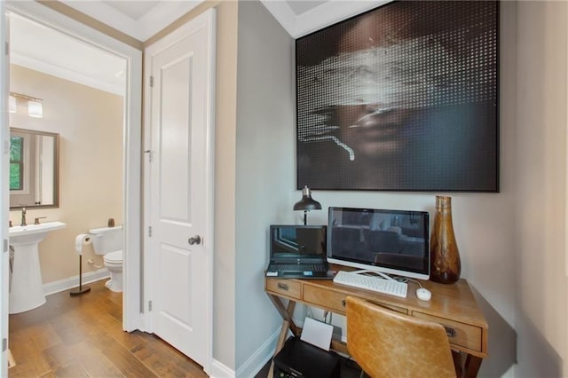 home office with hardwood / wood-style flooring and ornamental molding