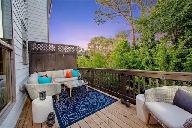 deck at dusk with outdoor lounge area