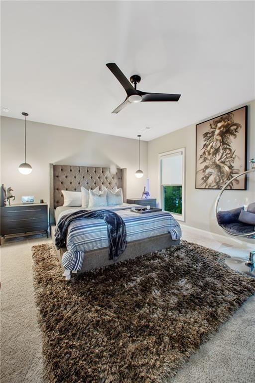 carpeted bedroom with ceiling fan