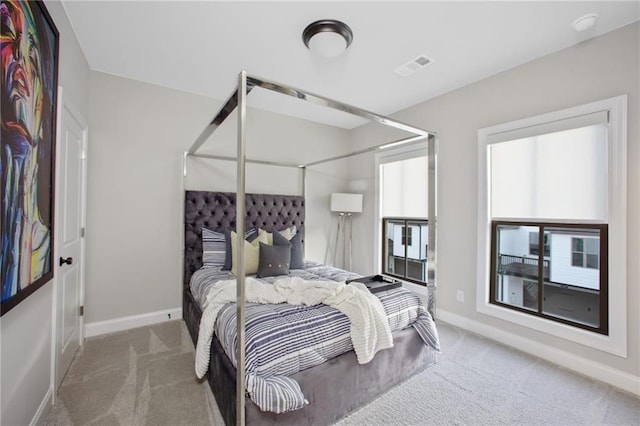 bedroom with carpet flooring and multiple windows