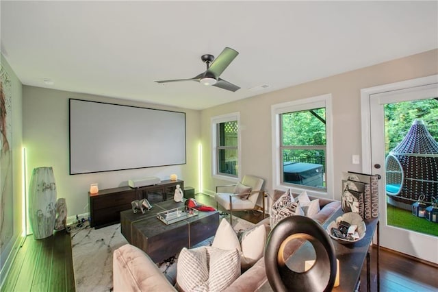 home theater featuring ceiling fan and hardwood / wood-style floors