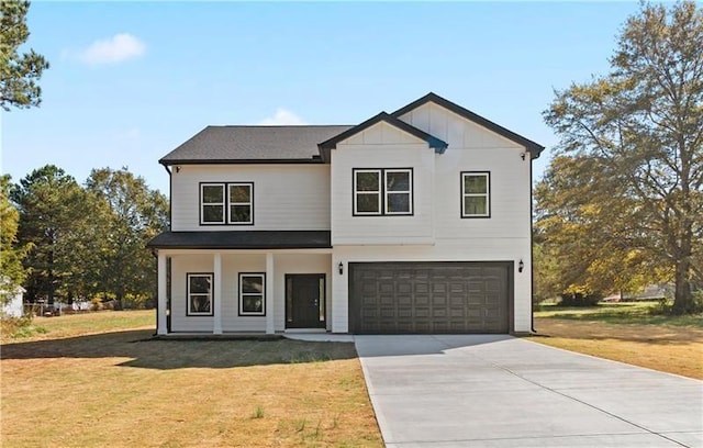 view of front facade with a front yard and a garage