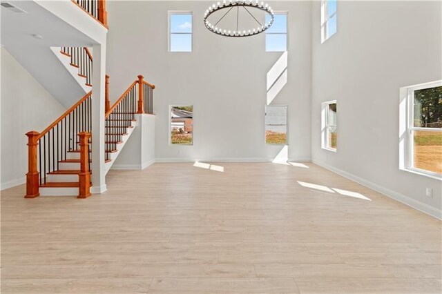 unfurnished living room with light hardwood / wood-style flooring and a healthy amount of sunlight