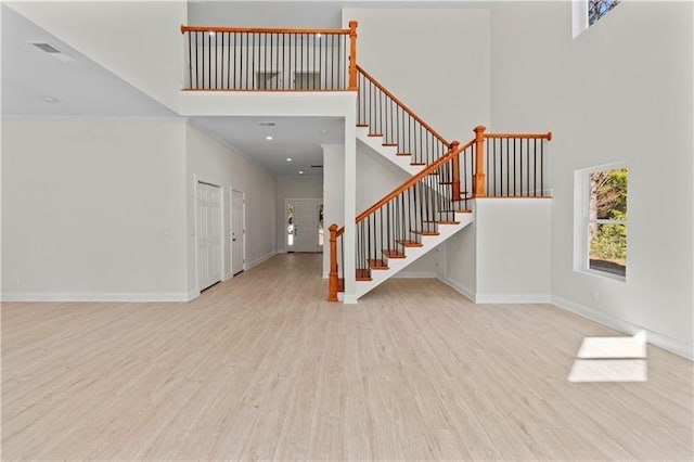 entrance foyer featuring a high ceiling and light wood-type flooring