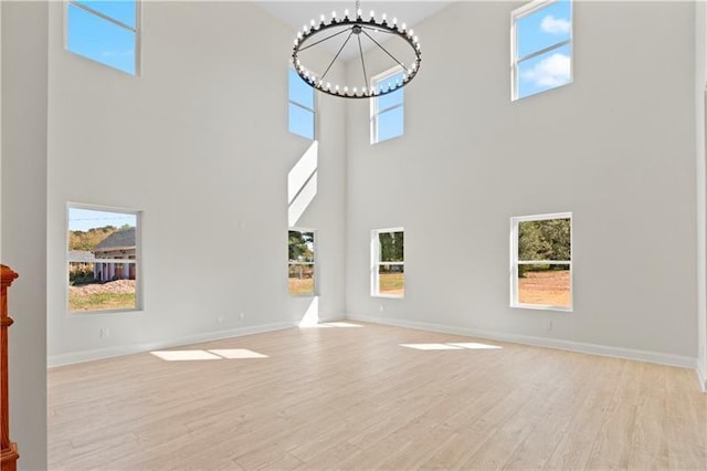 unfurnished living room with basketball hoop and a high ceiling