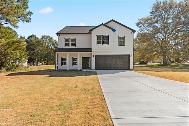 view of front of house featuring a front yard and a garage