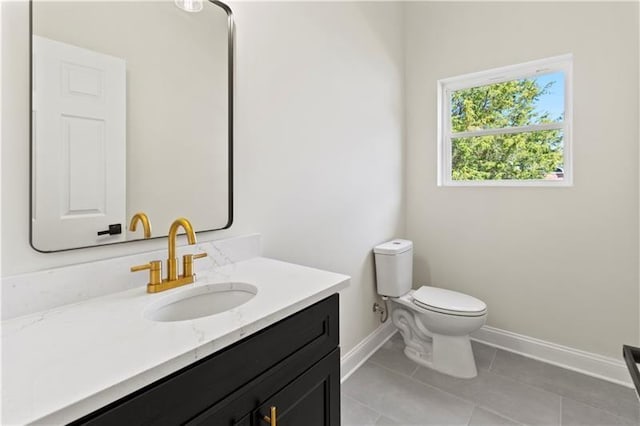 bathroom with toilet, tile patterned flooring, and vanity