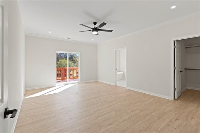 interior space with light wood-type flooring, connected bathroom, crown molding, and access to exterior