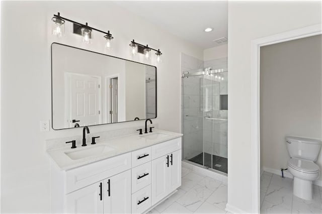 bathroom with toilet, a shower with shower door, and vanity