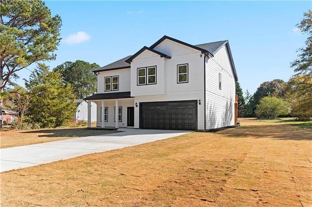 modern inspired farmhouse with a front yard and a garage