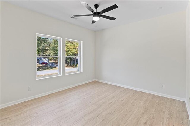 spare room featuring ceiling fan and light hardwood / wood-style floors