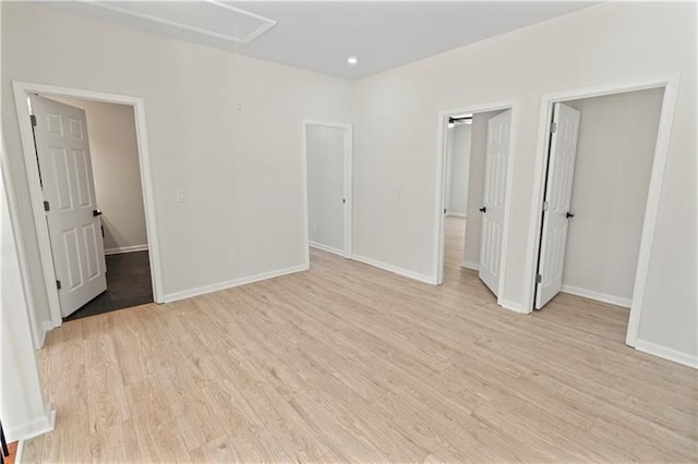 unfurnished bedroom featuring light hardwood / wood-style flooring and a closet