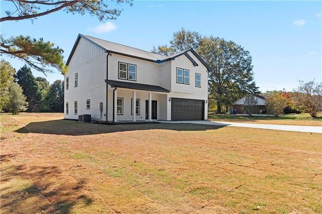 view of front of property featuring central AC unit, a garage, a porch, and a front lawn