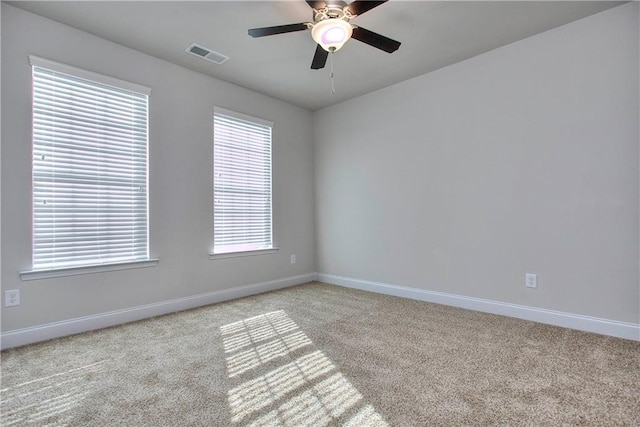 empty room featuring light carpet and ceiling fan