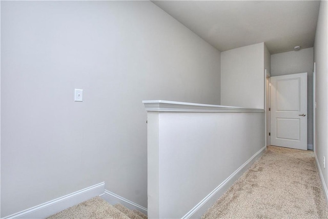 corridor with light colored carpet