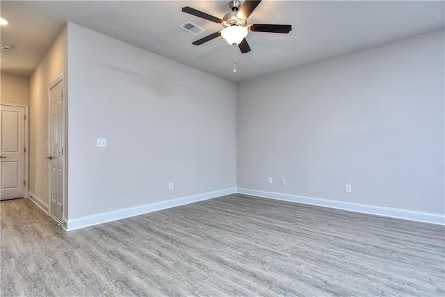 empty room with ceiling fan and wood-type flooring