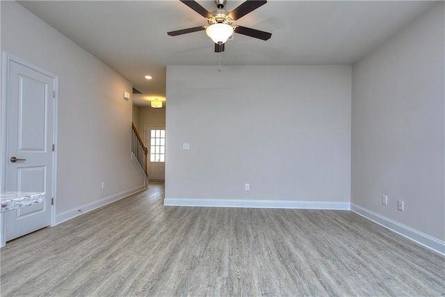 empty room featuring ceiling fan and light hardwood / wood-style flooring