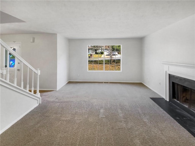 unfurnished living room featuring carpet flooring