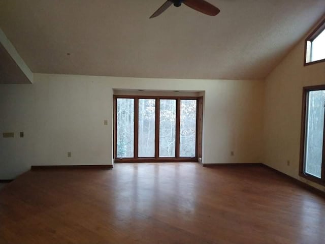 interior space featuring plenty of natural light, ceiling fan, and dark hardwood / wood-style flooring