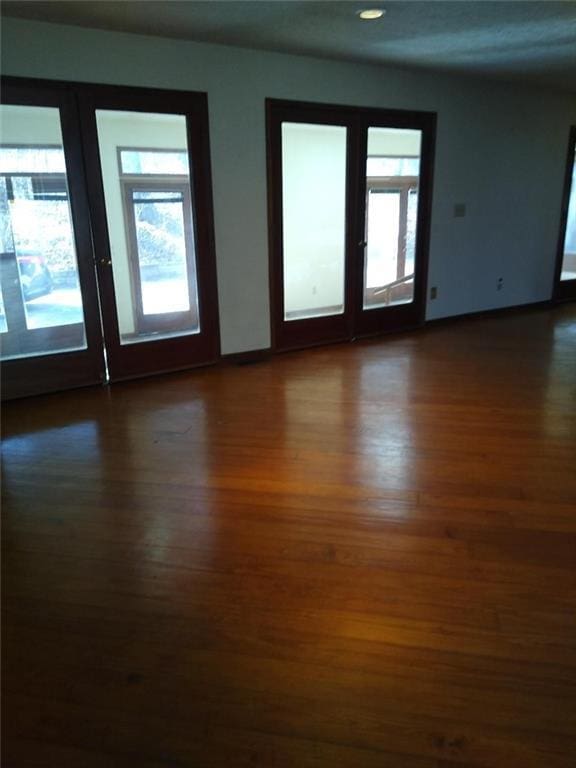 unfurnished room featuring dark wood-type flooring