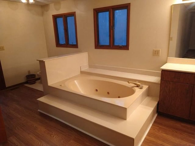 bathroom featuring vanity, hardwood / wood-style floors, and a bathtub