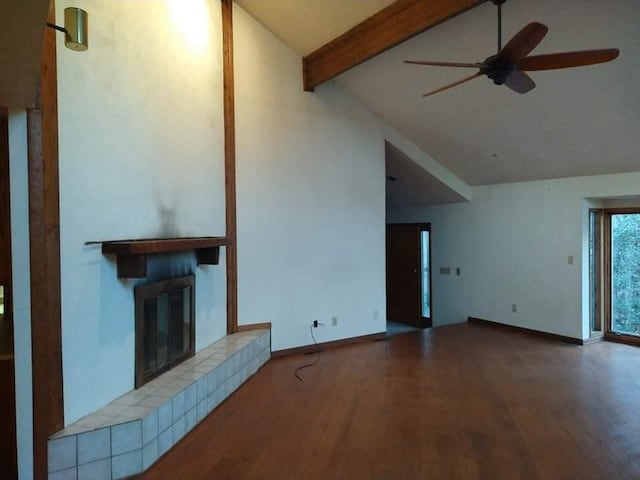 unfurnished living room with high vaulted ceiling, hardwood / wood-style flooring, beam ceiling, a fireplace, and ceiling fan