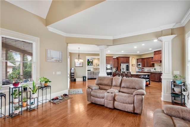 living area with ornamental molding, baseboards, light wood-style flooring, and ornate columns