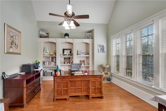 office featuring vaulted ceiling, baseboards, light wood-style flooring, and a ceiling fan