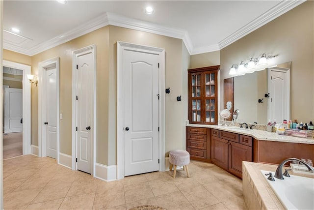 full bathroom featuring tiled bath, baseboards, ornamental molding, tile patterned floors, and vanity