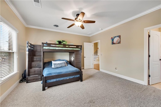 bedroom featuring carpet floors, ornamental molding, visible vents, and baseboards