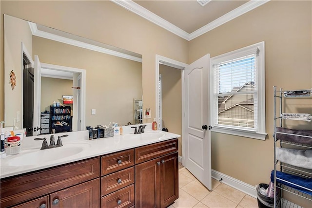 bathroom featuring tile patterned flooring, a sink, baseboards, ornamental molding, and double vanity